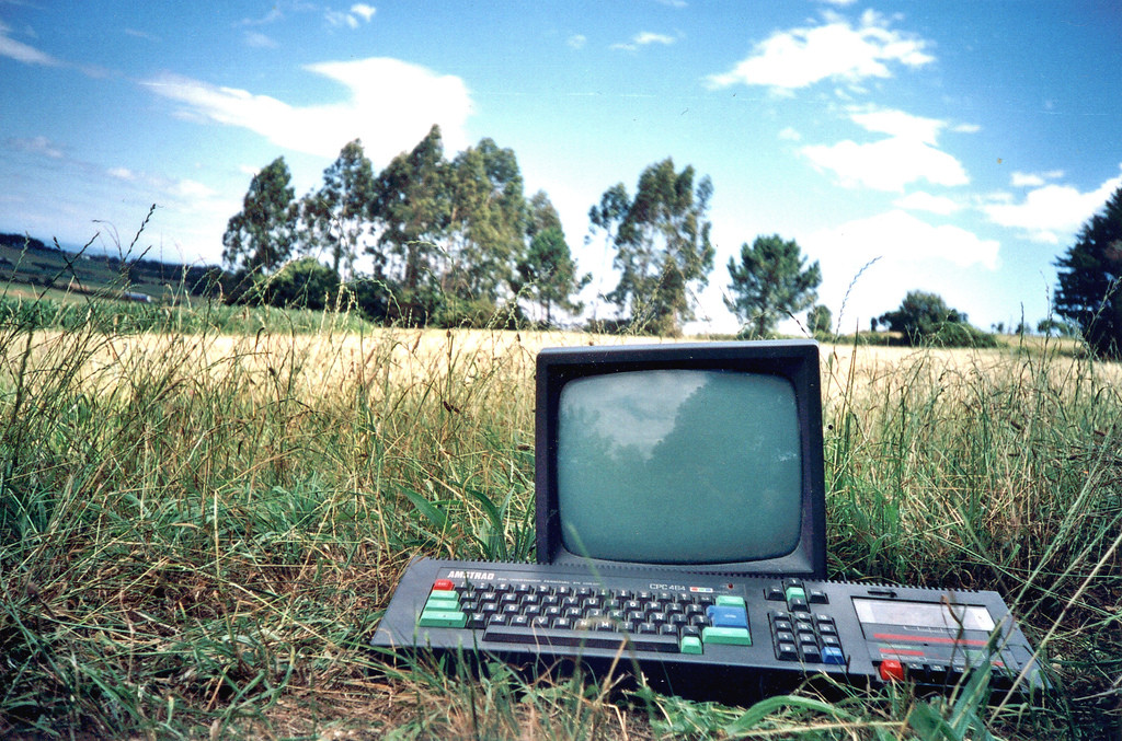a wallpaper with an Amstrad CPC 464 in the nature